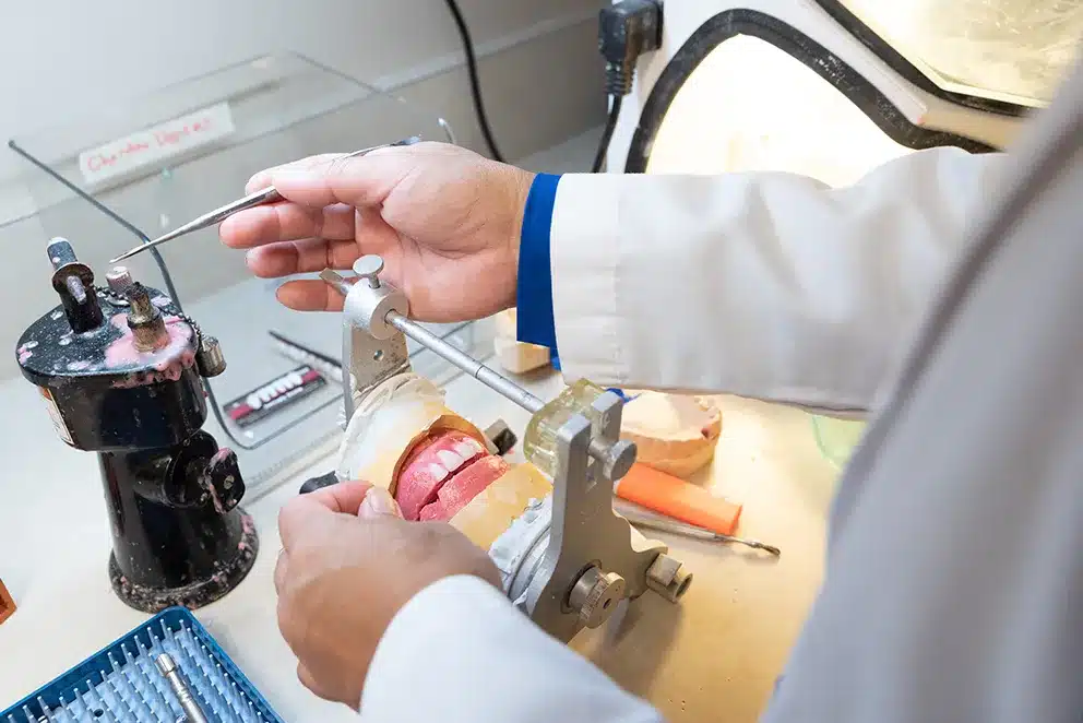 Our Plano dentist, Dr. Hopkins, crafting dentures for a patient.